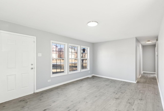 entrance foyer with baseboards and wood finished floors