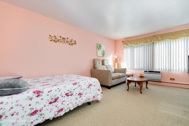 bedroom with carpet floors and a wall unit AC