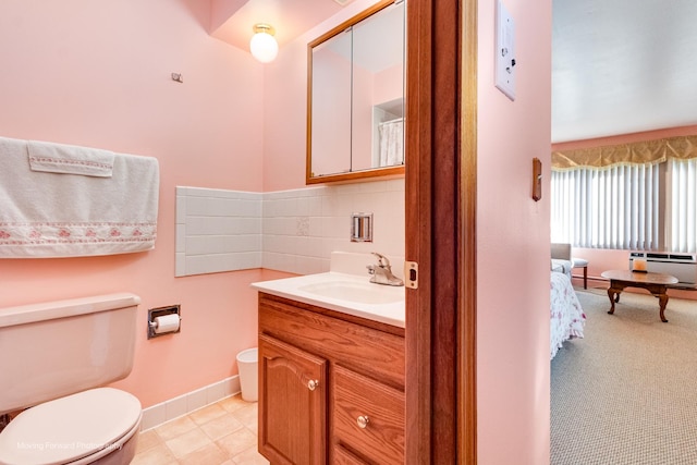 full bathroom featuring backsplash, toilet, ensuite bathroom, vanity, and baseboards