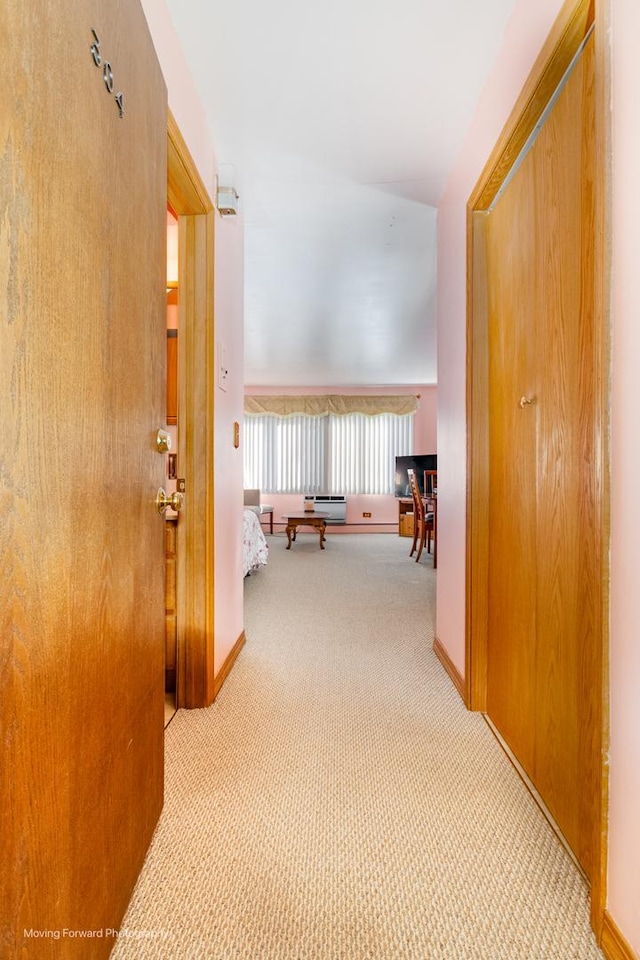 corridor featuring carpet flooring and baseboards