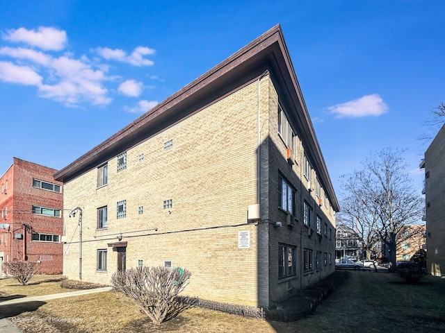 view of property exterior featuring brick siding