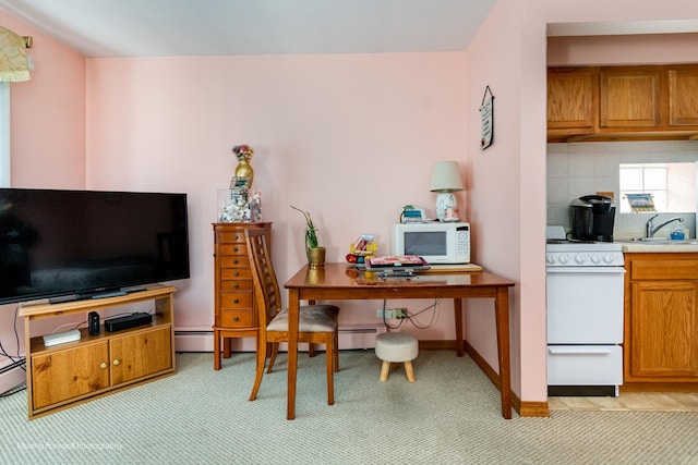 home office featuring baseboards, a sink, and light colored carpet