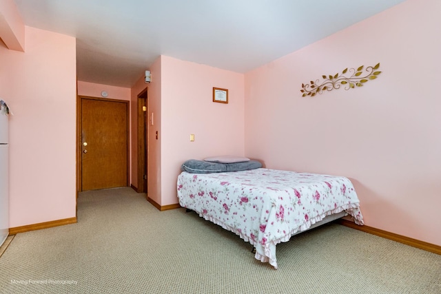 bedroom with carpet floors and baseboards