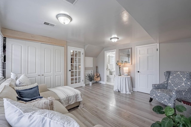 sitting room with light wood finished floors, baseboards, and visible vents