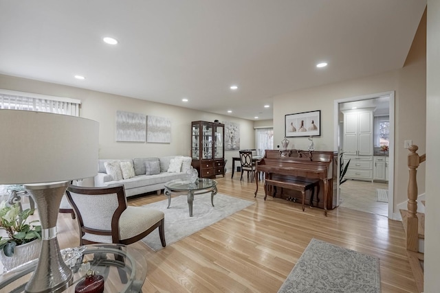 living area with light wood-style flooring and recessed lighting