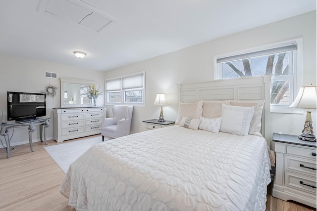 bedroom with visible vents, light wood finished floors, and multiple windows