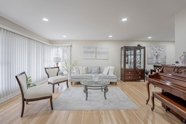 living room featuring light wood-type flooring and recessed lighting