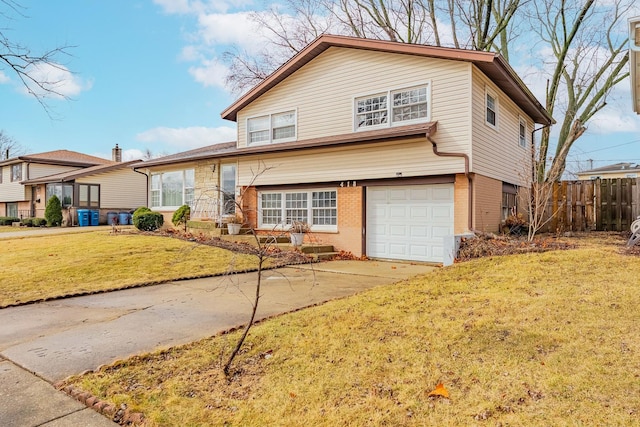 split level home with an attached garage, brick siding, fence, concrete driveway, and a front lawn