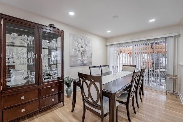 dining room with light wood-style flooring, baseboards, and recessed lighting