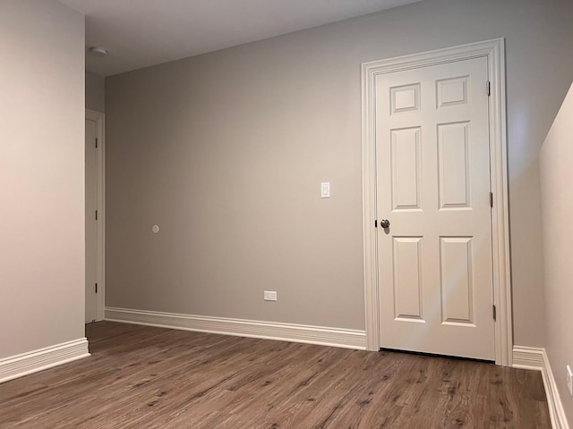 empty room featuring baseboards and wood finished floors