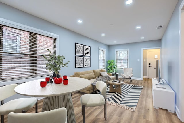 dining space with light wood finished floors, baseboards, visible vents, and recessed lighting