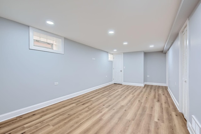 basement with light wood-type flooring, visible vents, baseboards, and recessed lighting