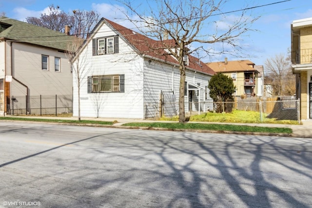 view of side of property featuring fence