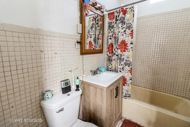 full bath featuring toilet, vanity, tile walls, and shower / tub combo with curtain