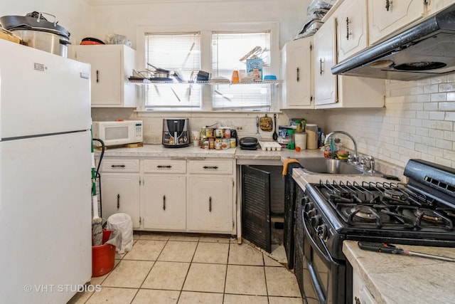 kitchen featuring light countertops, white appliances, a sink, and under cabinet range hood