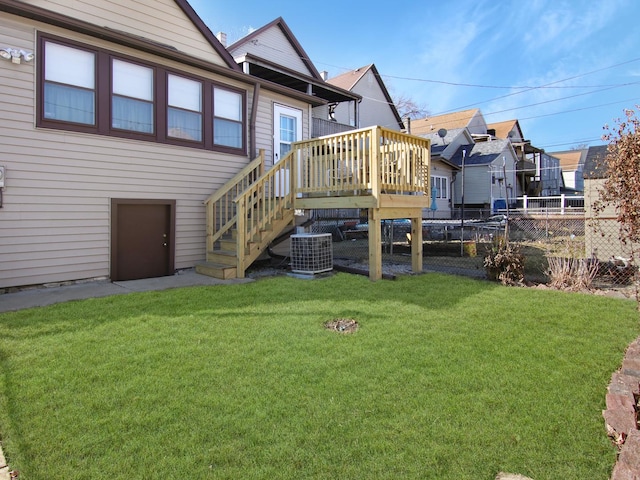 back of property with a deck, central AC, fence, a yard, and stairs