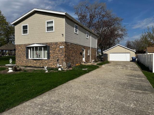 115 N Lavergne Ave, Northlake, IL 60164 - view of property exterior featuring brick siding, an outdoor structure, and a detached garage