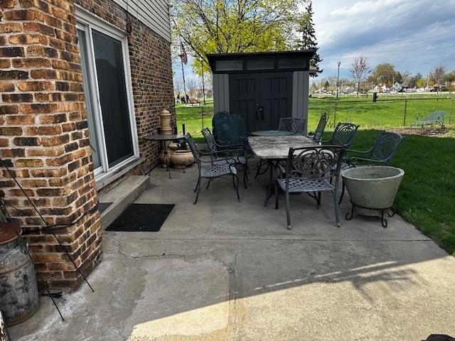 115 N Lavergne Ave, Northlake, IL 60164 - view of patio / terrace with outdoor dining area, a shed, and an outbuilding