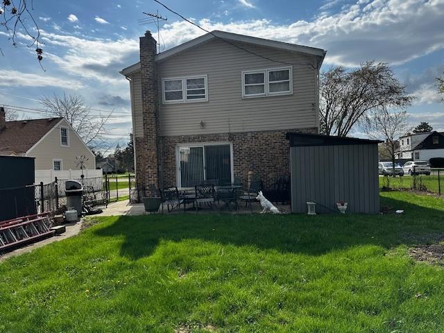 115 N Lavergne Ave, Northlake, IL 60164 - back of house with brick siding, a chimney, and a patio