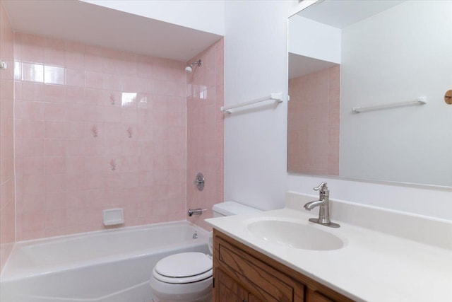 bathroom featuring toilet, tub / shower combination, and vanity