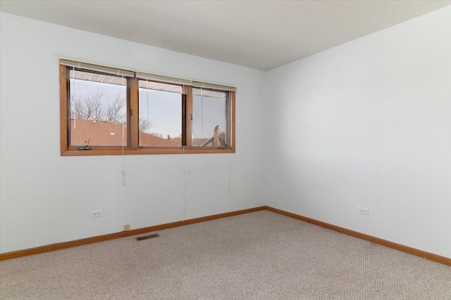 carpeted empty room with baseboards and visible vents