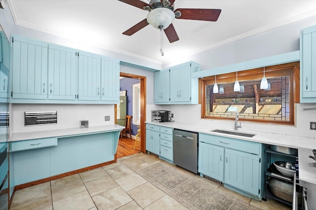 kitchen featuring blue cabinets, stainless steel dishwasher, light countertops, and a sink