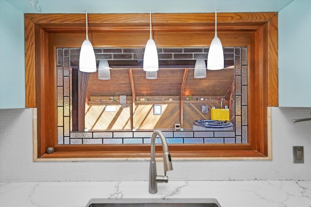 details with decorative light fixtures and a sink