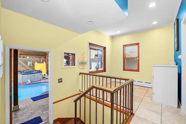 corridor featuring an upstairs landing, a baseboard heating unit, recessed lighting, crown molding, and light tile patterned floors