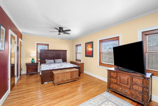 bedroom featuring a ceiling fan, crown molding, baseboards, and light wood-type flooring