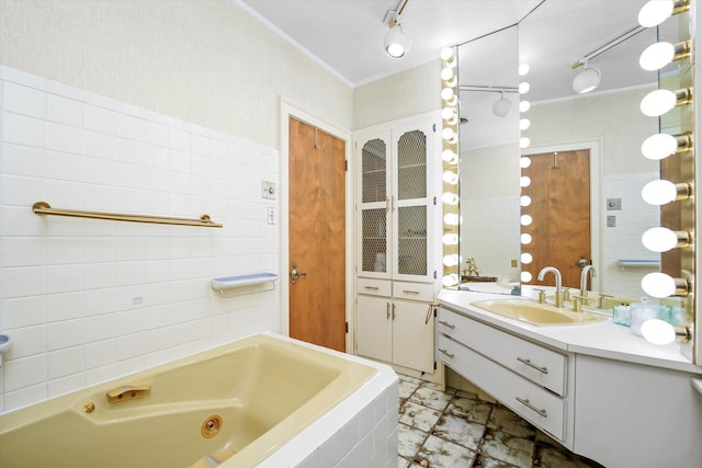 bathroom featuring vanity, tile walls, crown molding, and a relaxing tiled tub