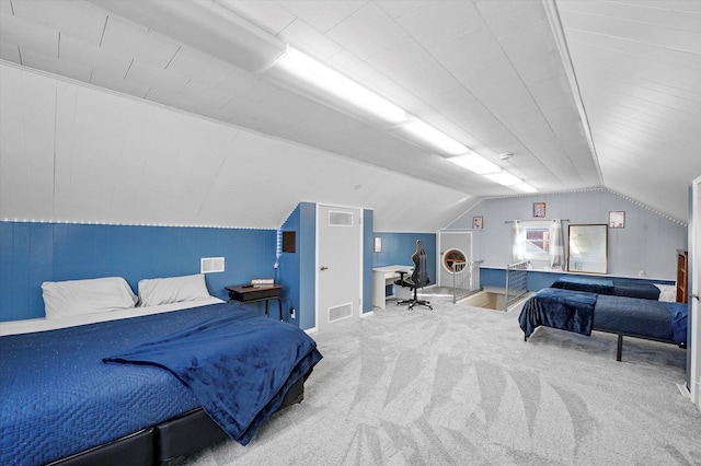 bedroom featuring visible vents, carpet floors, and vaulted ceiling