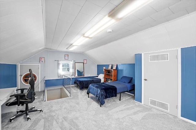 bedroom with vaulted ceiling, carpet flooring, and visible vents