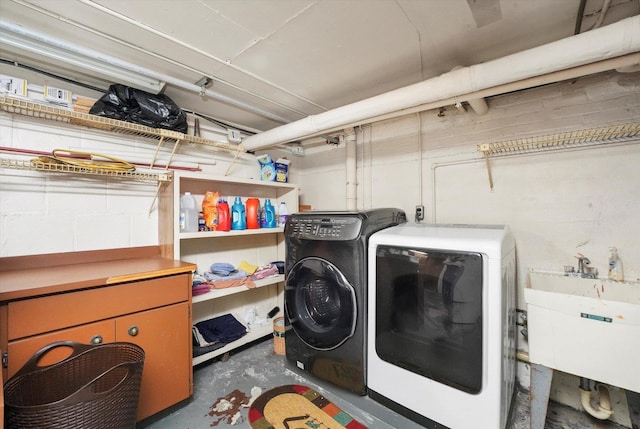 washroom with washer and dryer, laundry area, and a sink