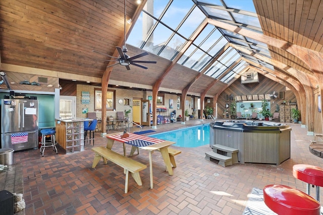 view of pool featuring an AC wall unit, a skylight, and ceiling fan