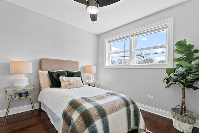 bedroom with a ceiling fan, wood finished floors, and baseboards