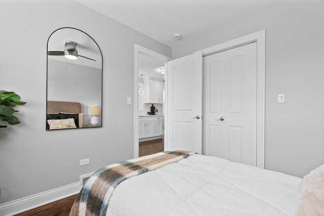 bedroom with dark wood-type flooring and baseboards