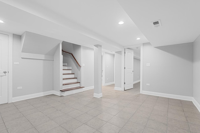 finished basement with recessed lighting, visible vents, baseboards, and stairway