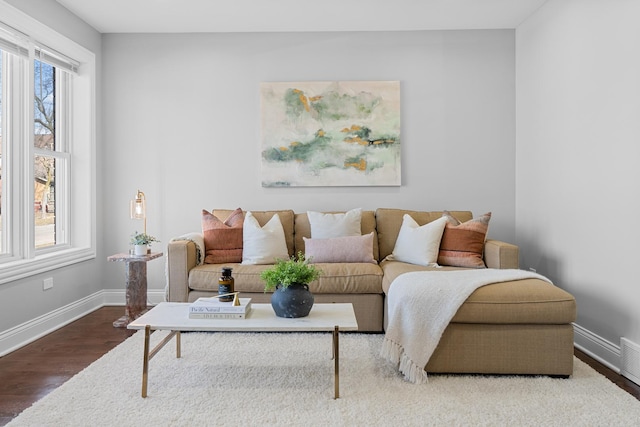 living area featuring baseboards and wood finished floors