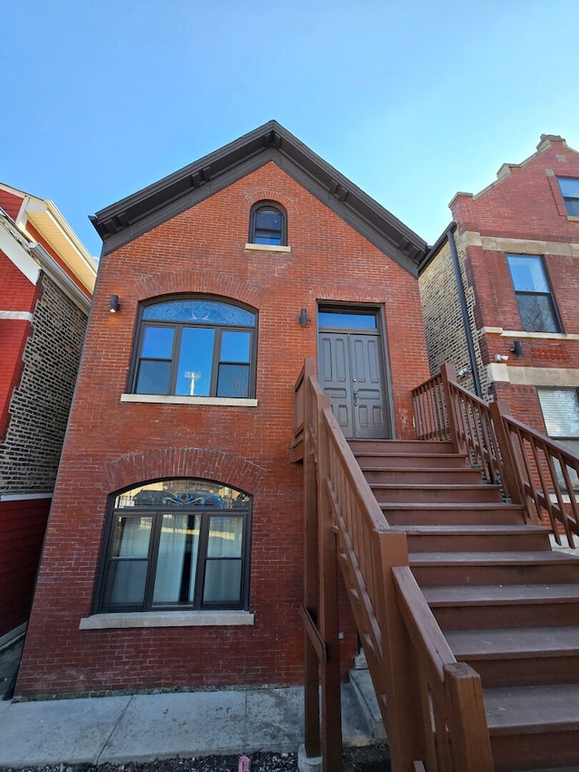 back of property featuring brick siding