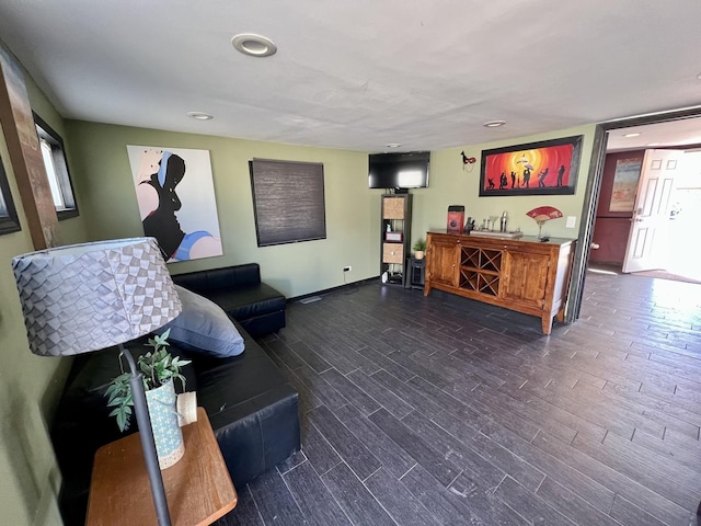 living room featuring recessed lighting, a dry bar, and wood finished floors