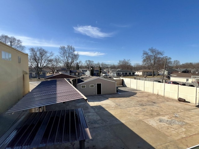 exterior space featuring a residential view, a patio, and fence