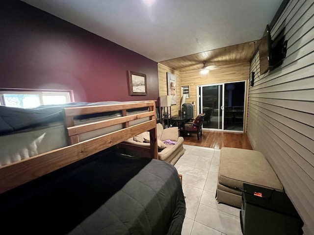 bedroom featuring wooden walls