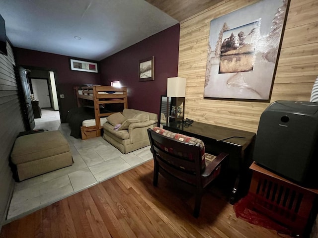 living room with wooden walls and wood finished floors