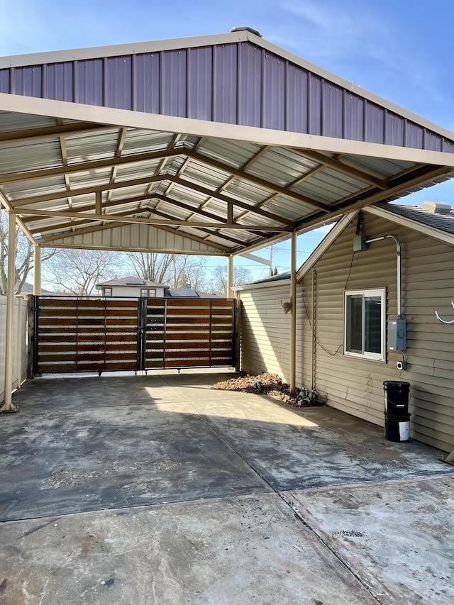 view of car parking with an attached carport and fence