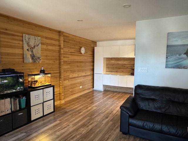 living area with wooden walls and wood finished floors