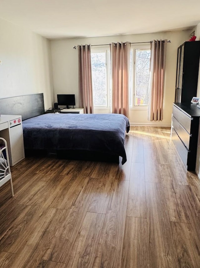 bedroom with wood finished floors