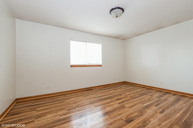 empty room with light wood-style floors and baseboards