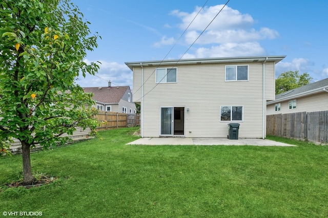 back of property featuring a fenced backyard, a lawn, and a patio