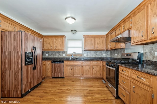 kitchen with dishwashing machine, stainless steel gas range oven, under cabinet range hood, refrigerator with ice dispenser, and light wood-style floors