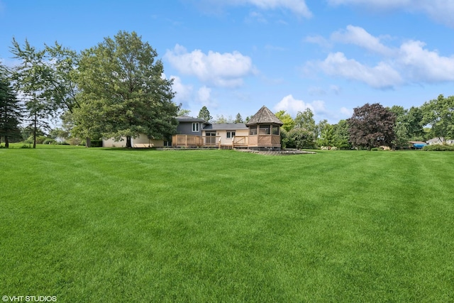 view of yard with a wooden deck and a gazebo